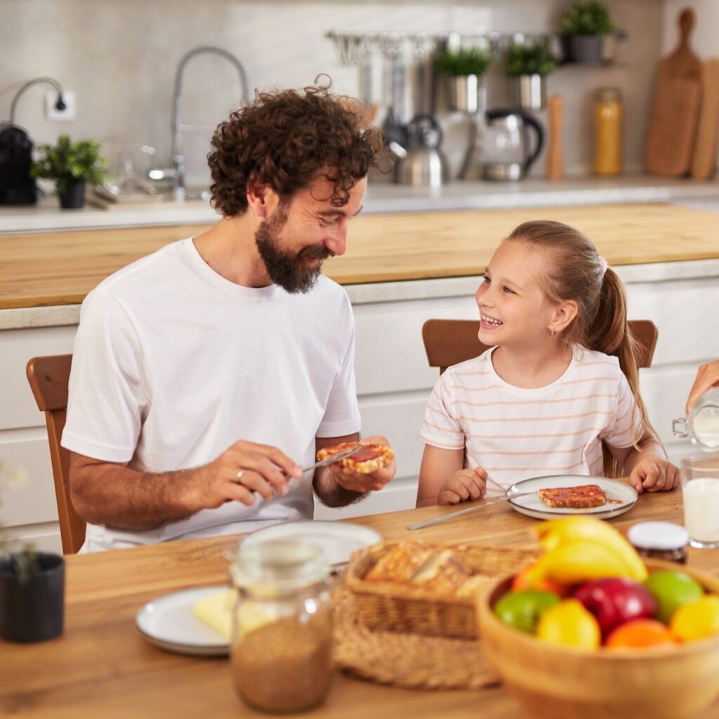 Happy family enjoying breakfast together in the kitchen