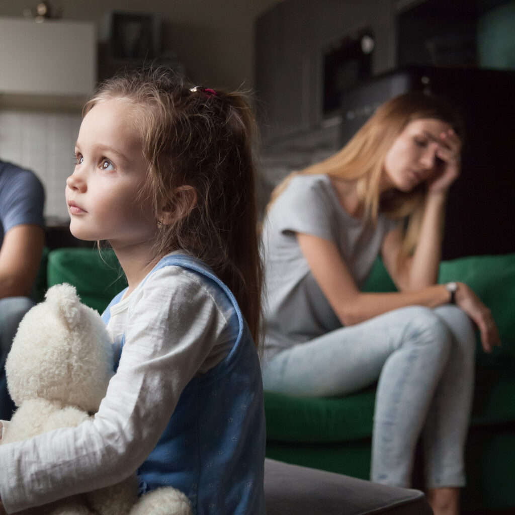 Upset, frustrated little girl tired of parents fight