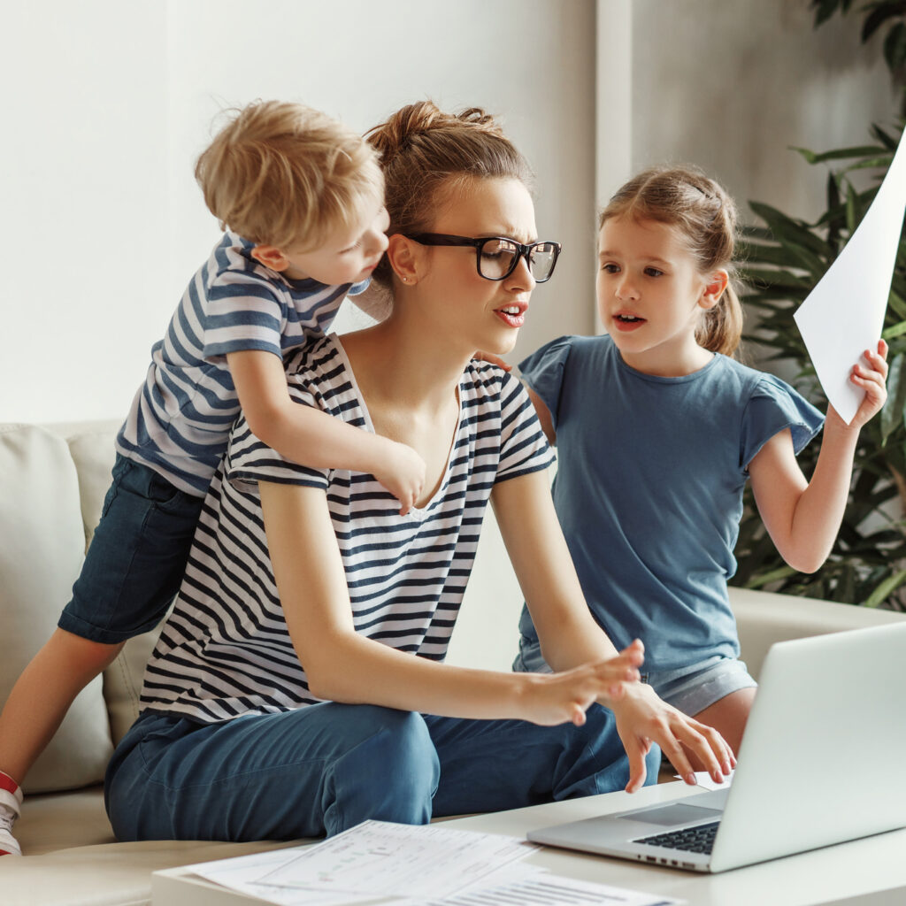 Stressed woman with kids working from home