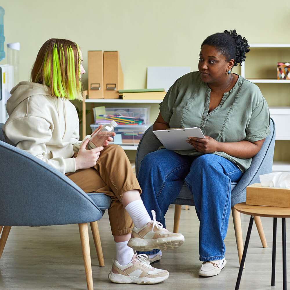 Older woman talking with a younger woman.