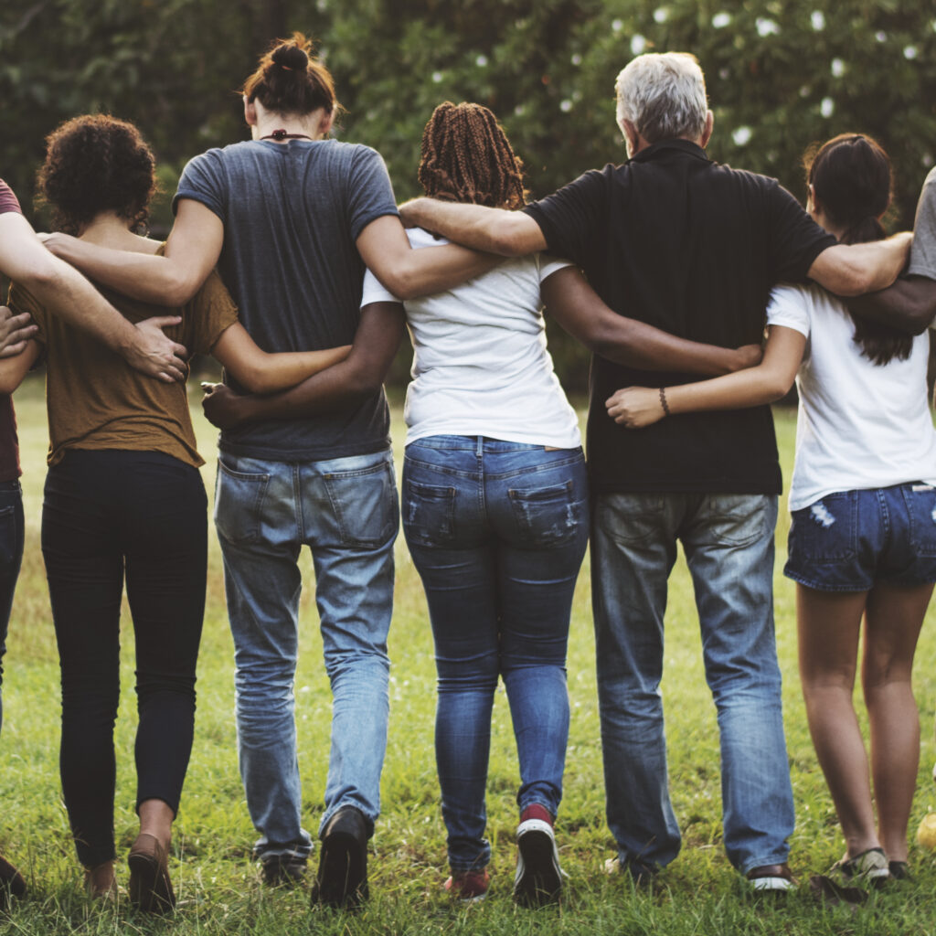 Group of friends huddle in rear view together