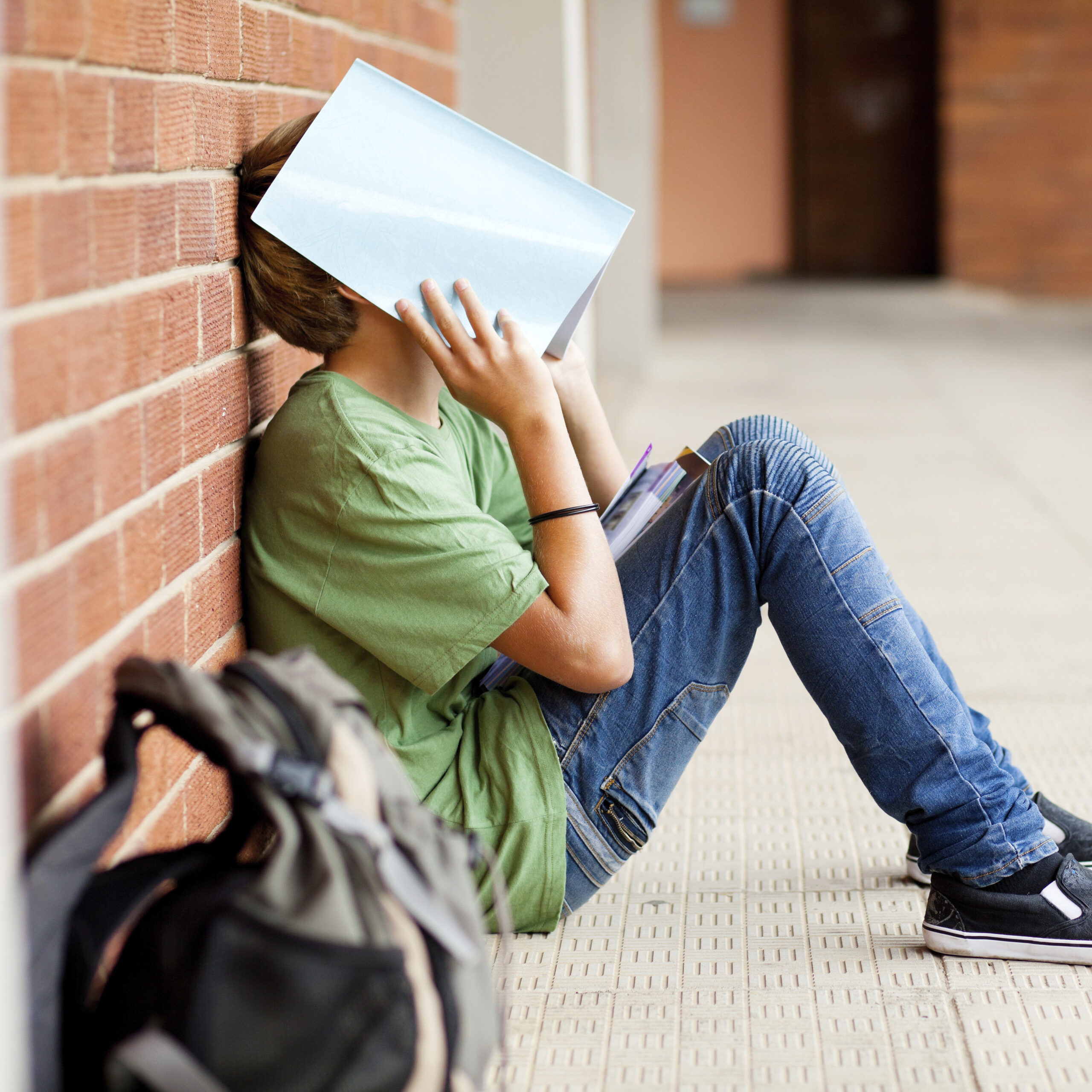 Teen sitting on ground