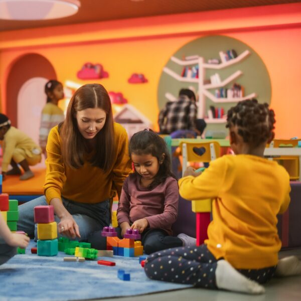 Cheerful diverse kids playing together in kindergarden day care